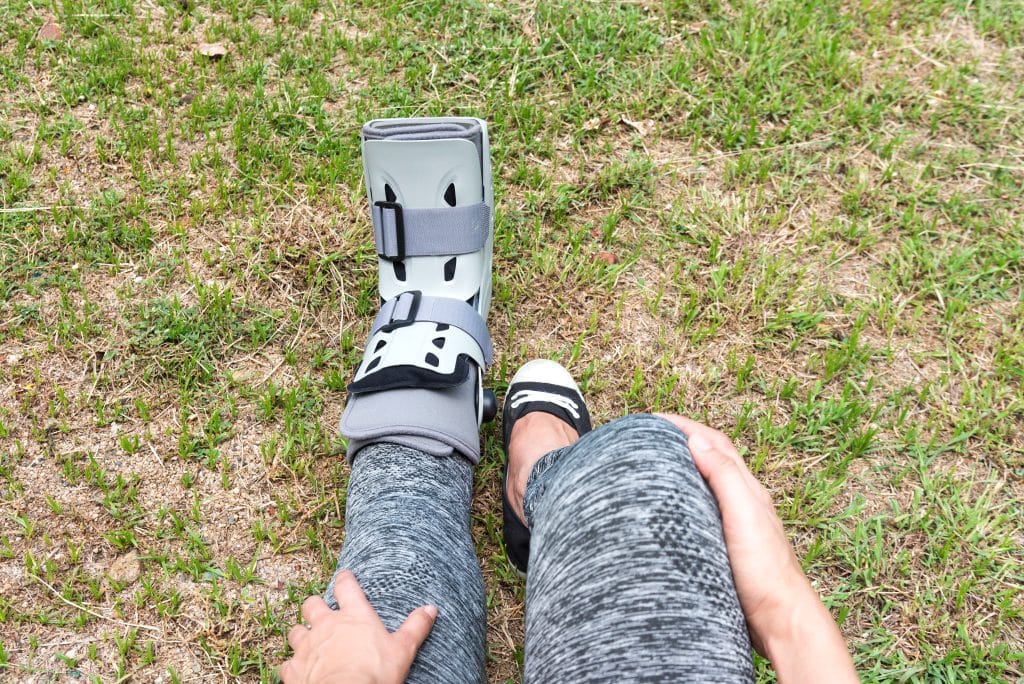 Woman with foot sprain wearing walking boot