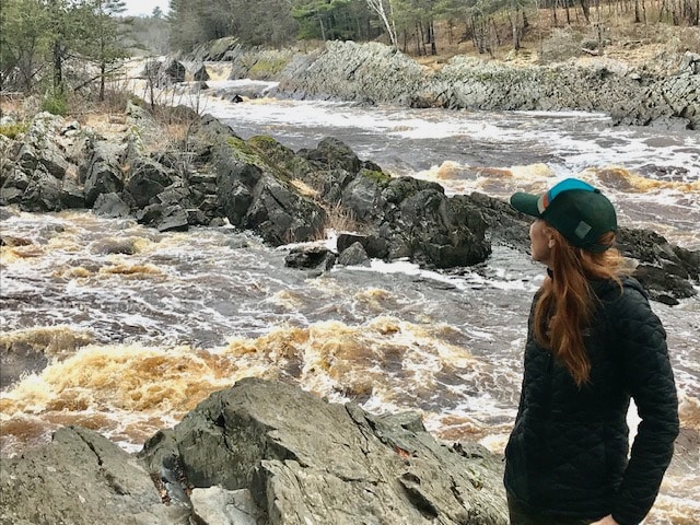 Dr. Kristina Reed looking out over a river with large rocks