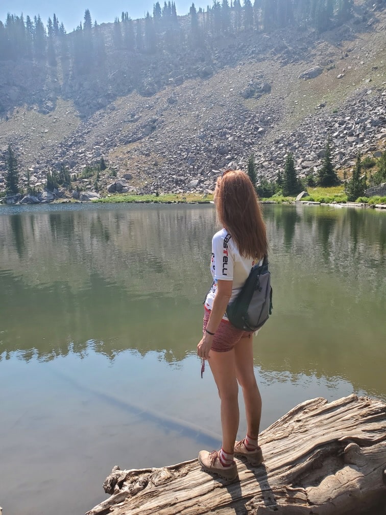 Dr. Kristina Reed looking at a pond while hiking