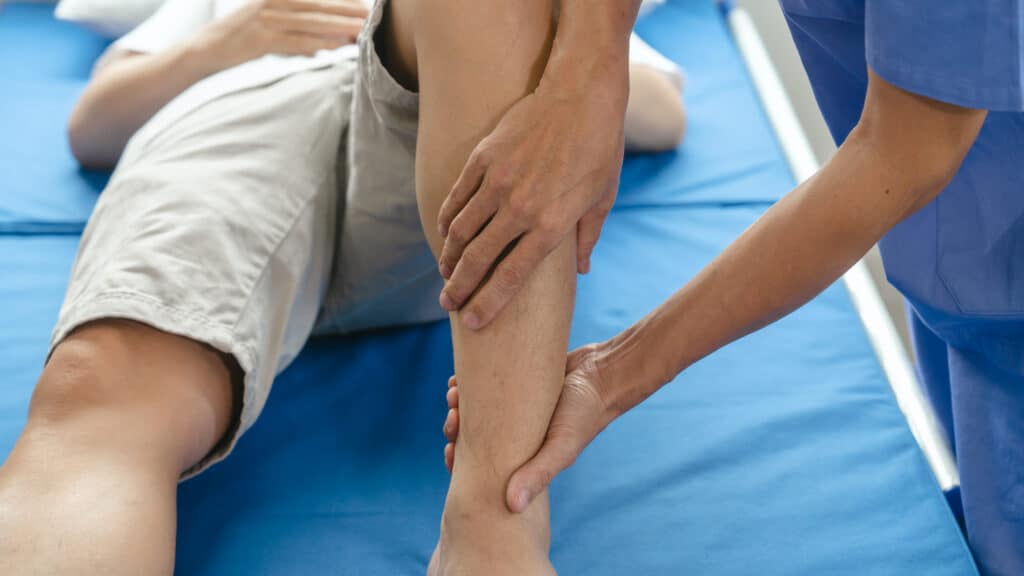 A person undergoing physical therapy as part of treatment for a fractured fibula.