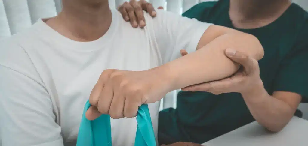 A person working with a physical therapist as part of rotator cuff surgery recovery.