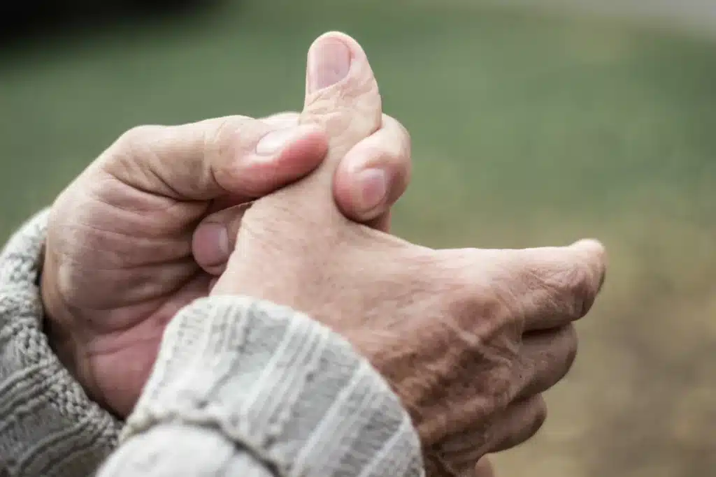 A person pressing on their thumb to relieve thumb pain.