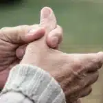 A person pressing on their thumb to relieve thumb pain.